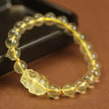 Yellow leather adjustable bracelet with a carved artificial crystal Pi Xiu charm.