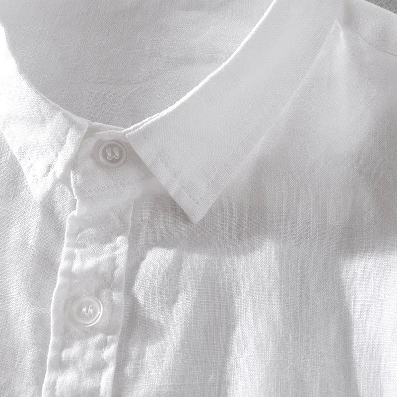 Man wearing a light blue loose fit short sleeve linen shirt for casual summer wear.