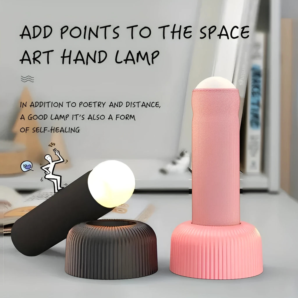 Creative handheld night light with fabric covering on base, emitting warm light