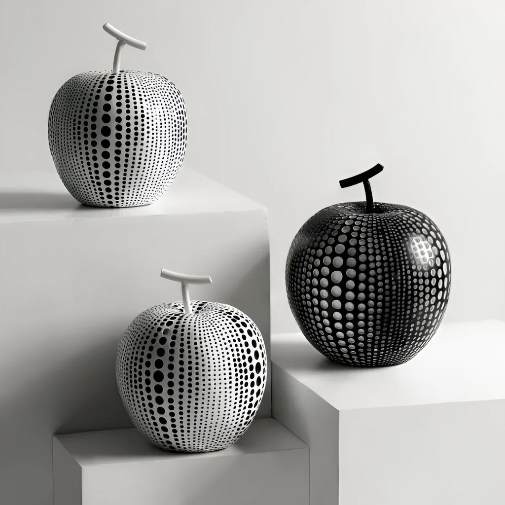 Resin craft decorative apple sculpture in black tall model with smooth finish on a white table