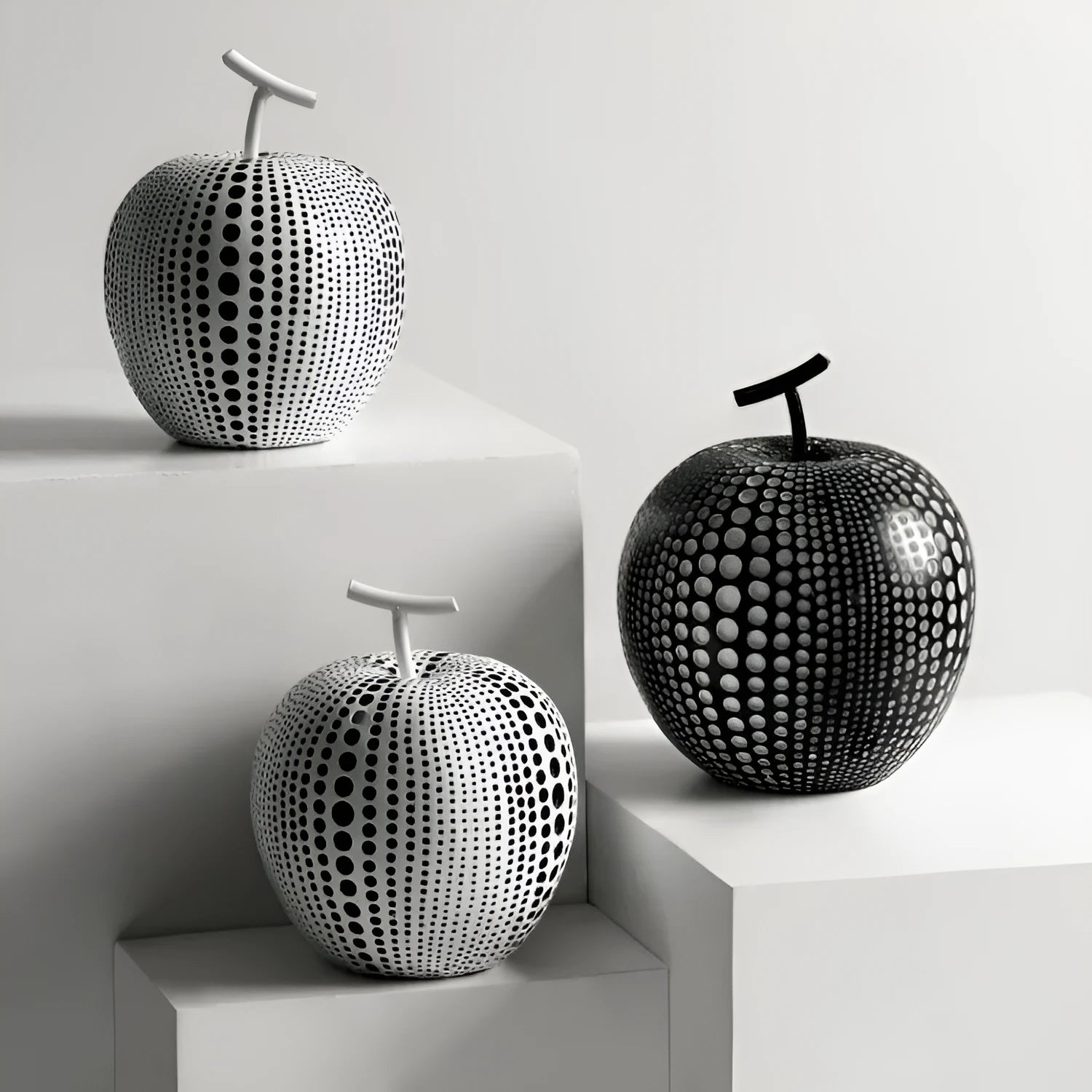 Resin craft decorative apple sculpture in black tall model with smooth finish on a white table