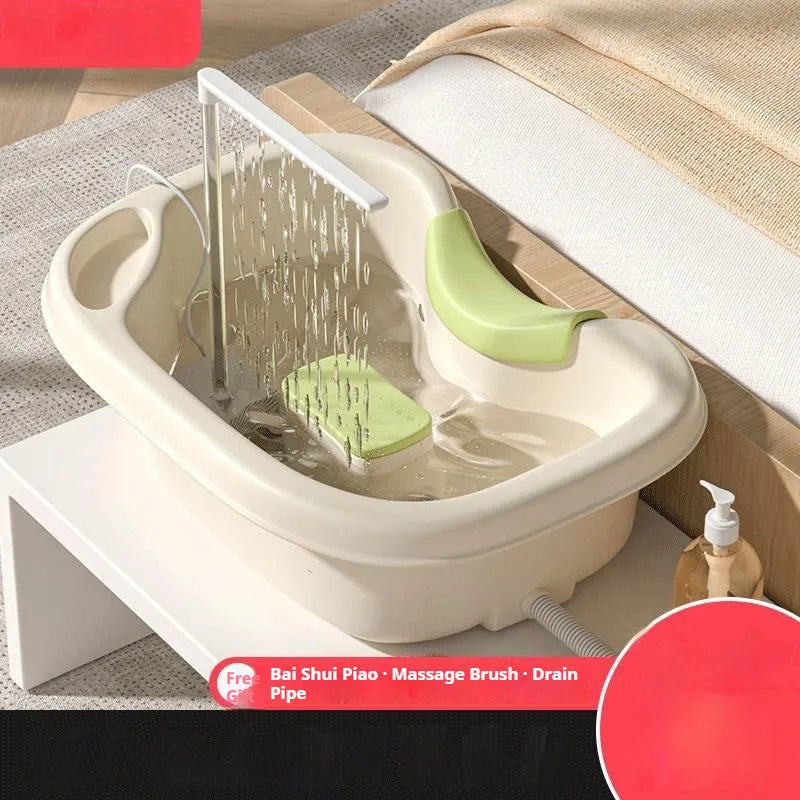 Beige and light pink plastic shampoo basin set for bed use with pump, pillow, and brush.