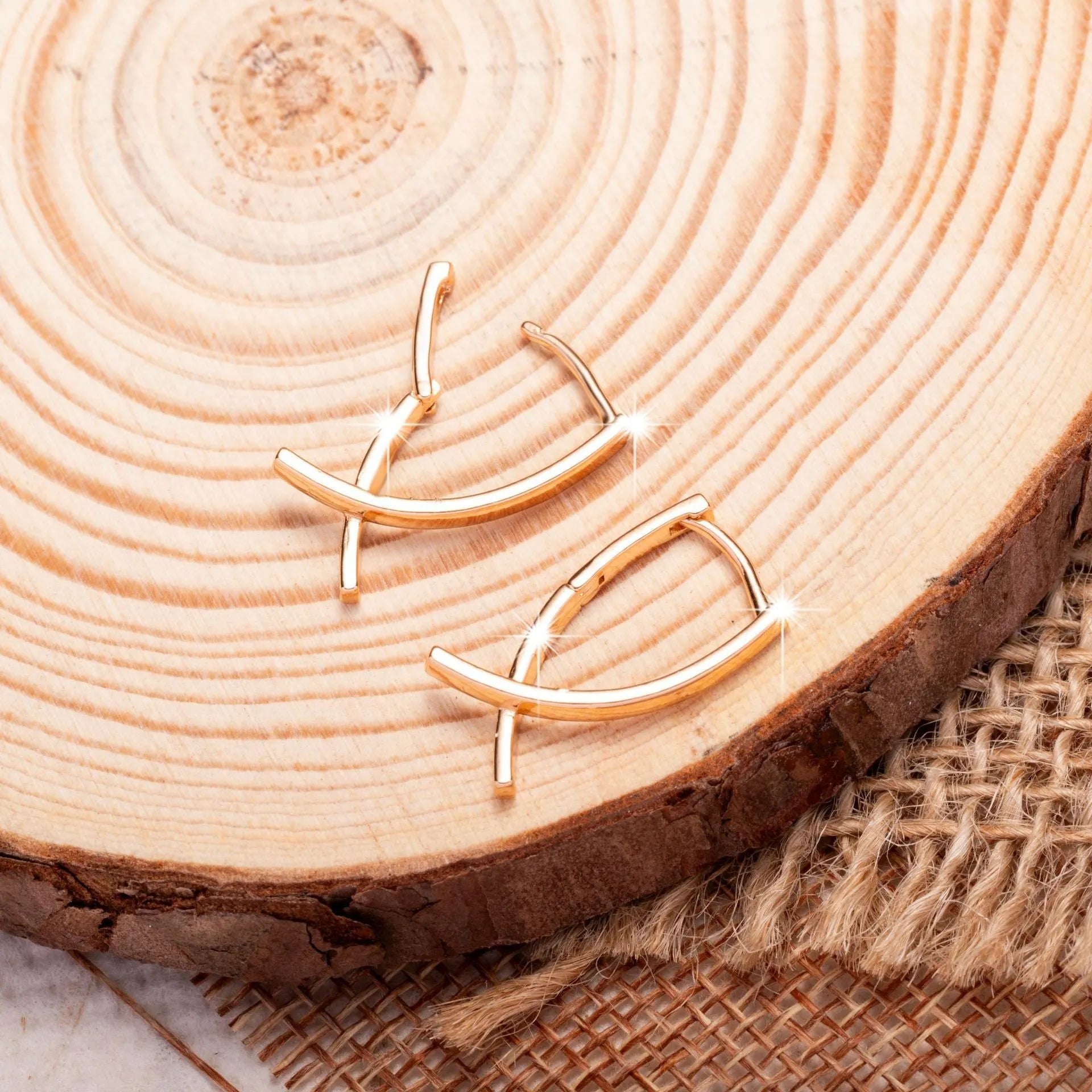 Rose gold coloured cross shaped drop earrings with contemporary light luxury styling