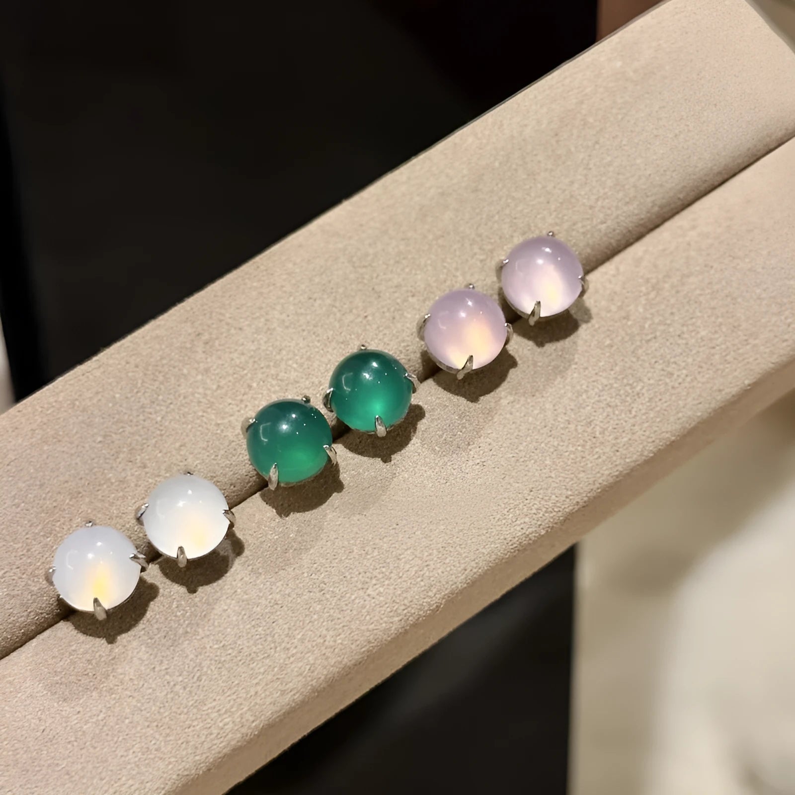 A pair of Chinese-style retro stud earrings with a round egg-shaped chalcedony stone in a four-claw copper setting.