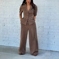 Brown men's two-piece polyester suit with a slim fit waist, shown on a hanger.
