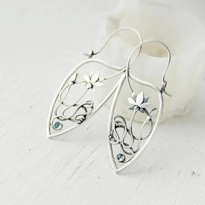 Silver lotus vine and geometric flower design earrings with rhinestone decoration on alloy base