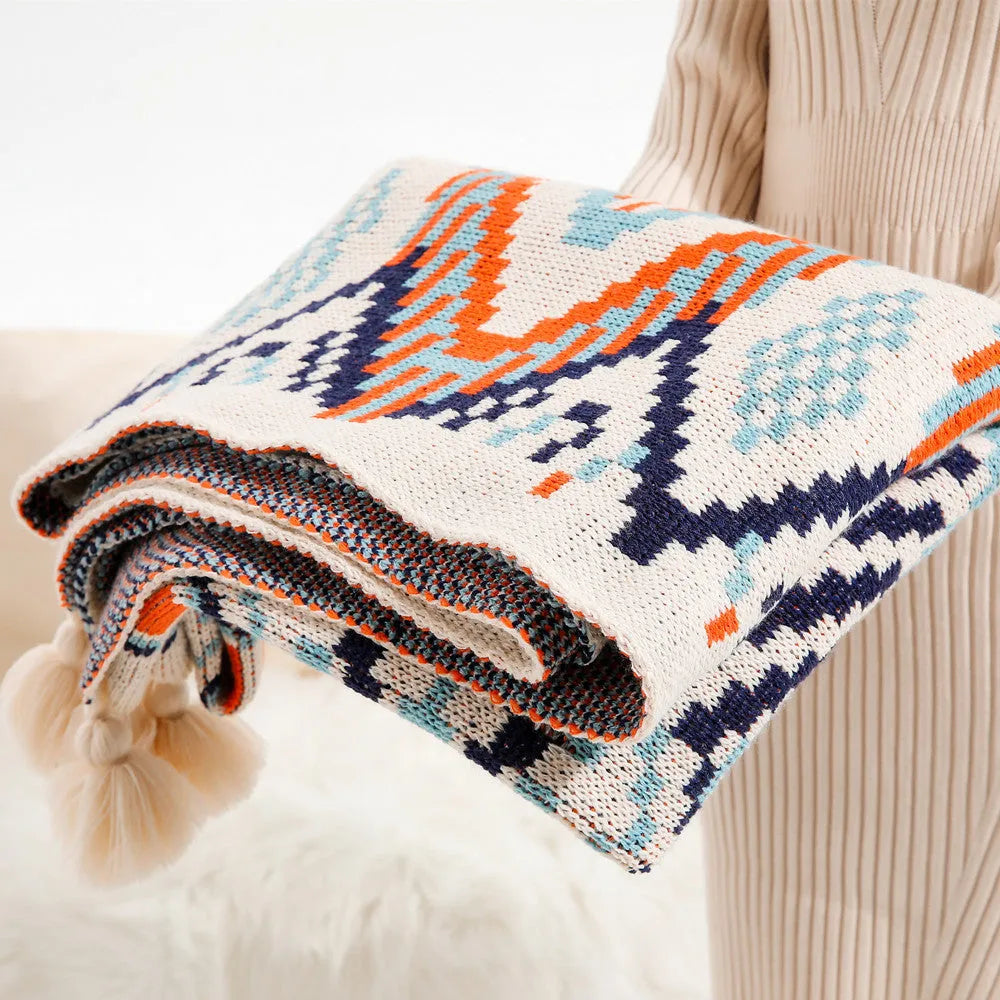 Bohemian-style acrylic sofa cover blanket with tassel trim in a geometric pattern colour option