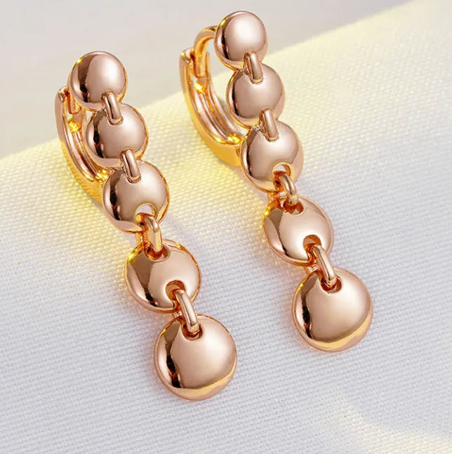 A pair of gold-coloured retro long round circle earrings with a woven texture, made from copper.