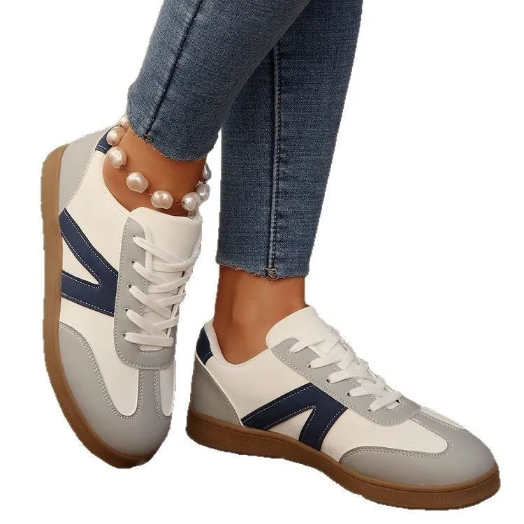 Blue women's low-top hiking shoes with artificial PU upper and rubber sole on a natural background.