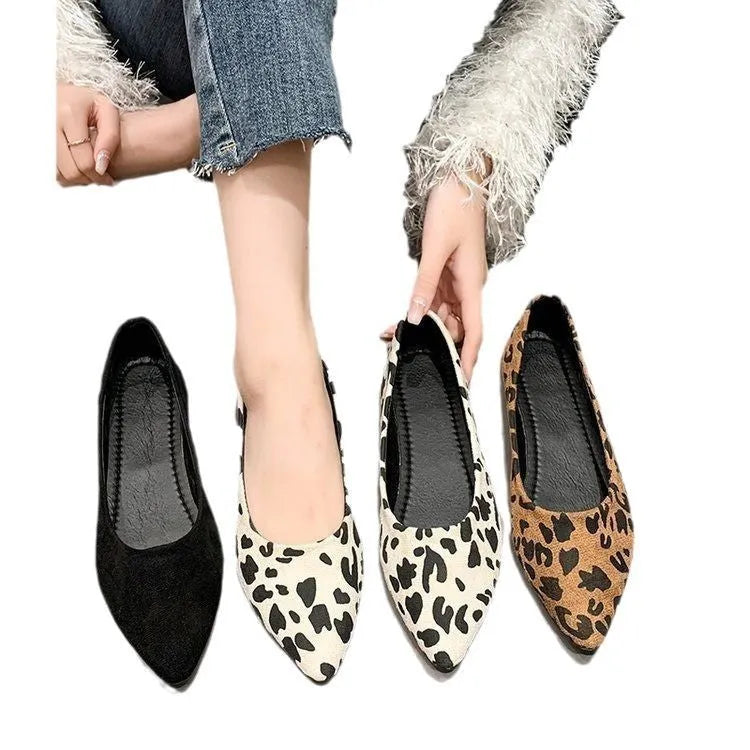Women's leopard print flat pumps with pointed toe and low heel on a cotton cloth upper.