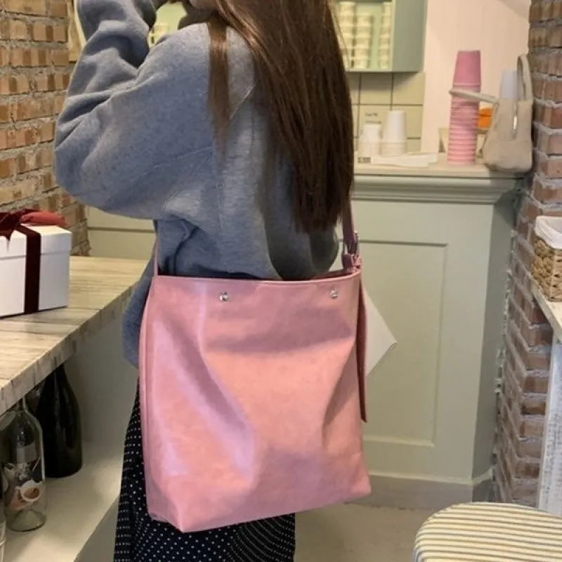 Corduroy one shoulder bag in pink or brown showing 39cm length and spacious interior for commuters