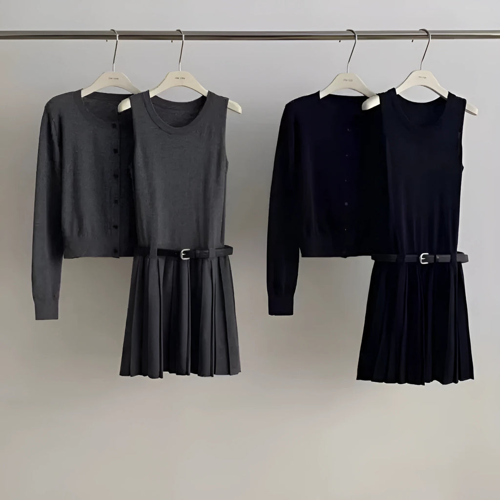 Women's black knitted two-piece set showing vest skirt with belt and long-sleeved cardigan with 3D pattern