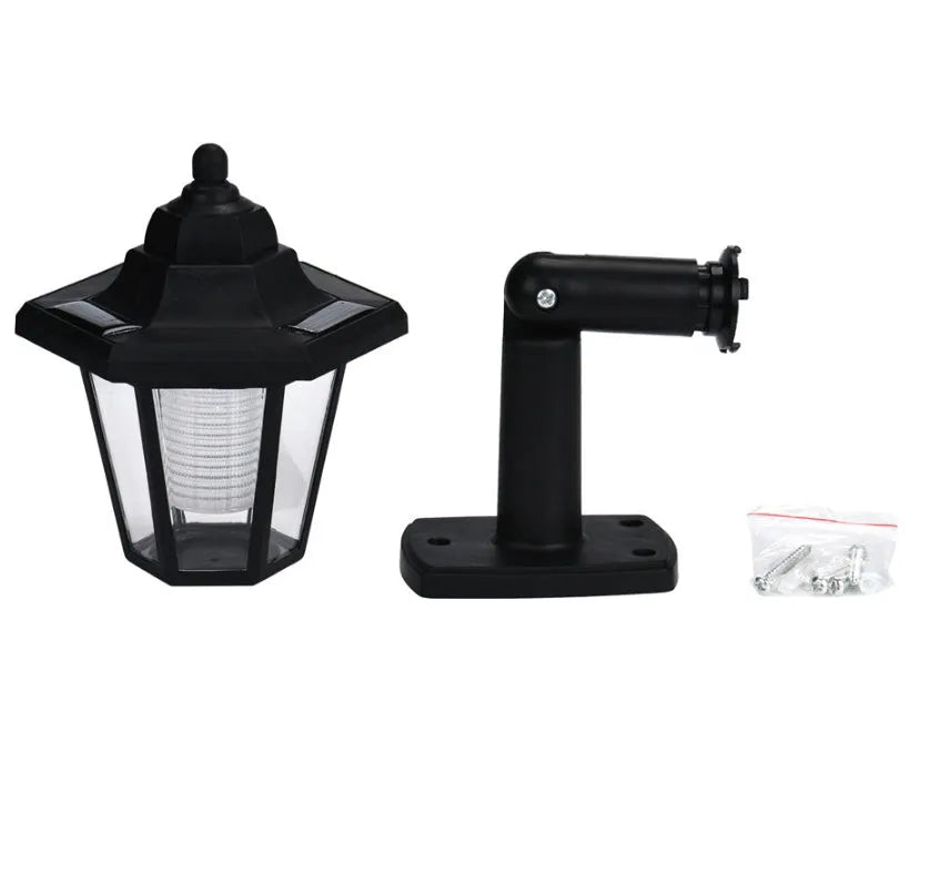 Black hexagonal solar-powered outdoor wall light with visible solar panel.