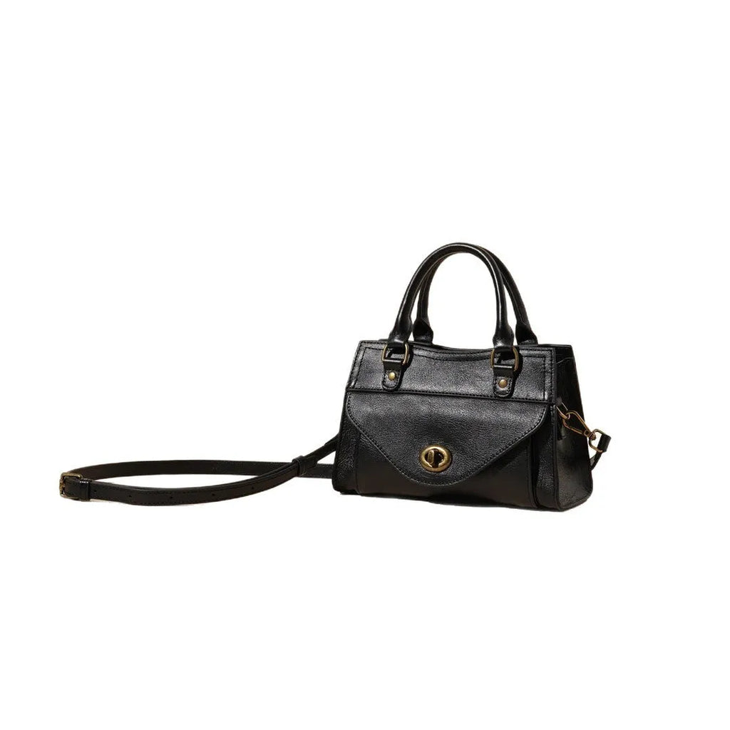 Genuine leather one-shoulder crossbody bag in solid colour with lock closure, horizontal square shape, and visible sewing thread details.