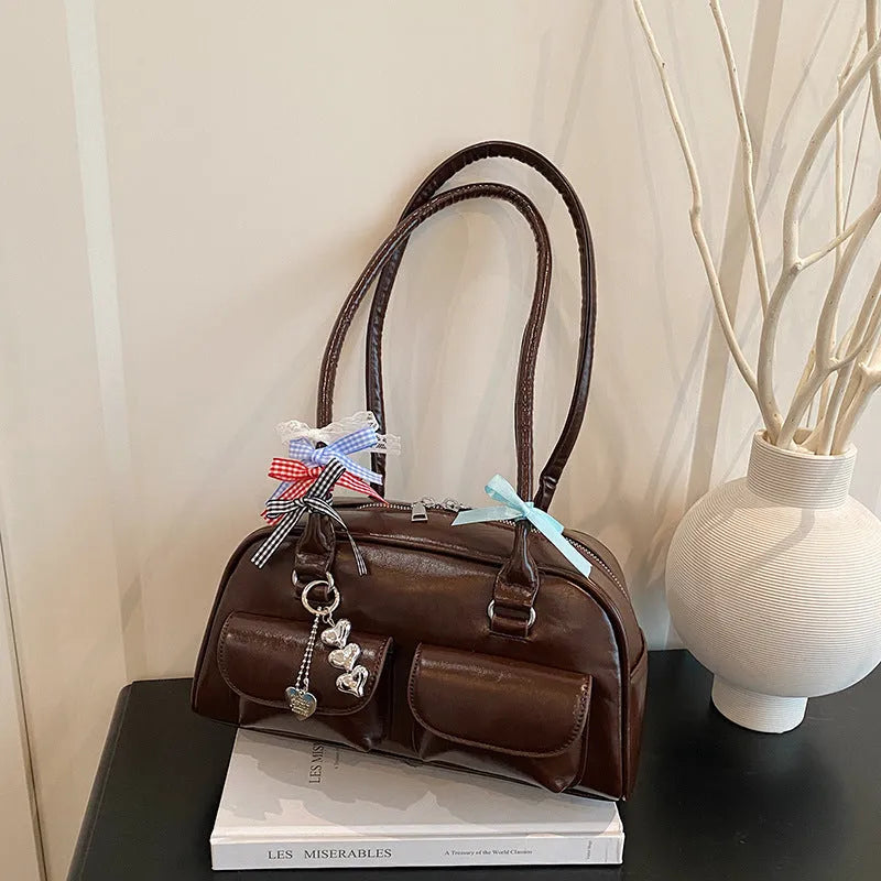 Women's black PU leather retro pillow handbag with flap closure and double shoulder straps.