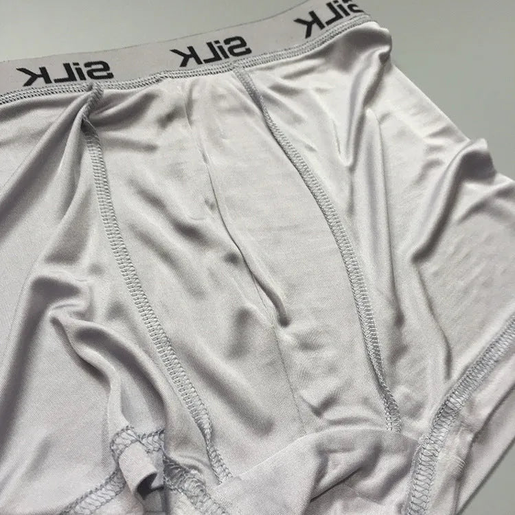 Men's loose-fitting silk shorts in navy blue, shown on a mid-waist, highlighting the breathable casual design.
