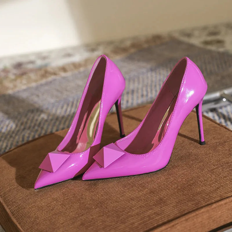 Women's pink pointed toe stiletto high heels with buckle detail on patent leather upper