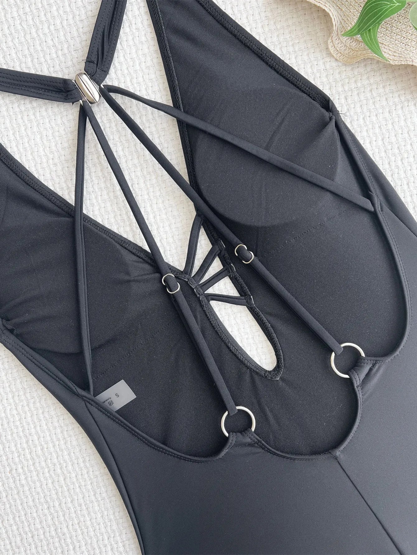 Women's solid black one-piece nylon swimsuit bikini on a white background.
