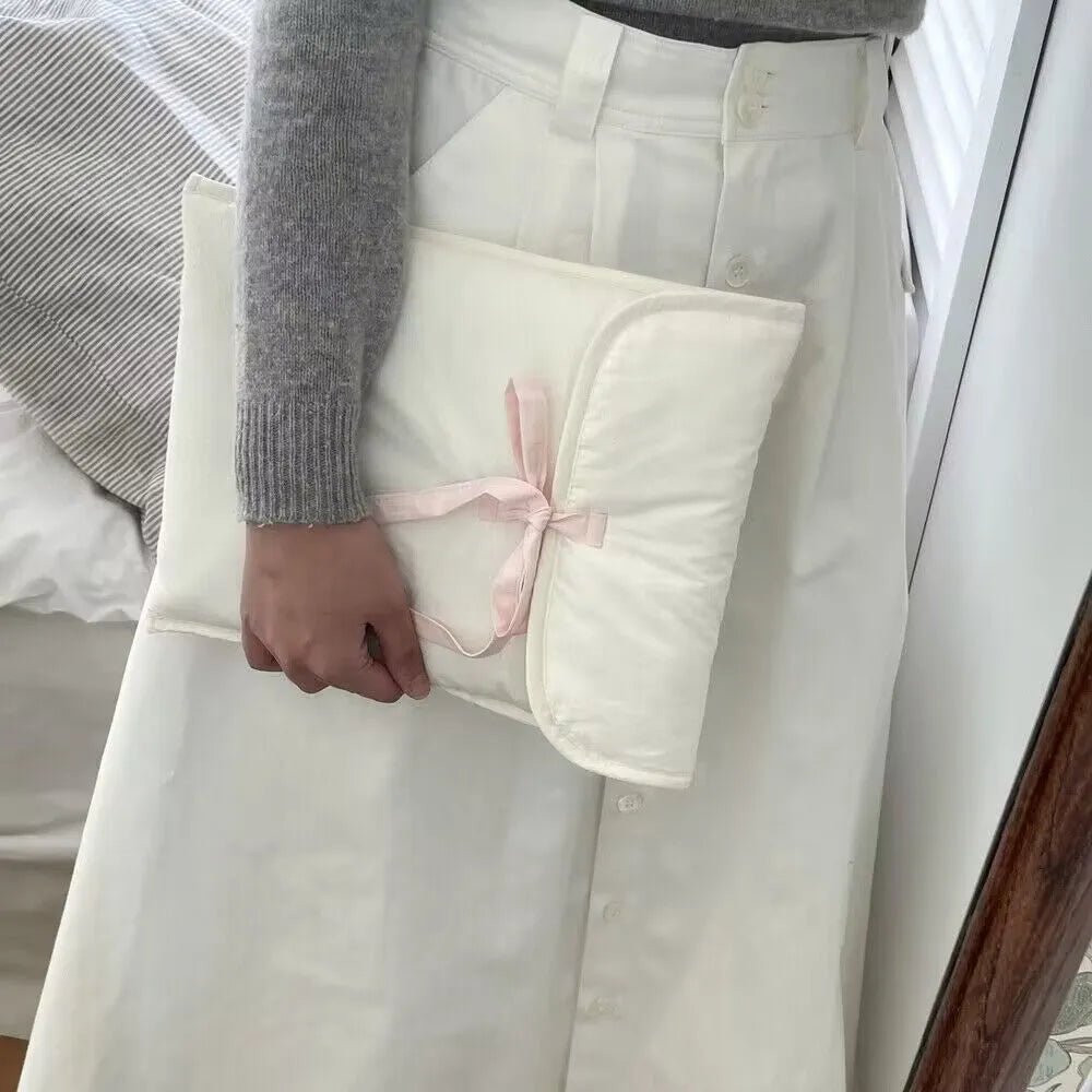 Women's black and white striped quilted computer bag with ballet style bow detail