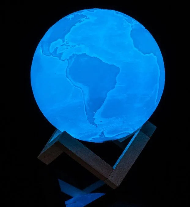 3D printed white moon lamp on a wooden stand with touch control ring at base