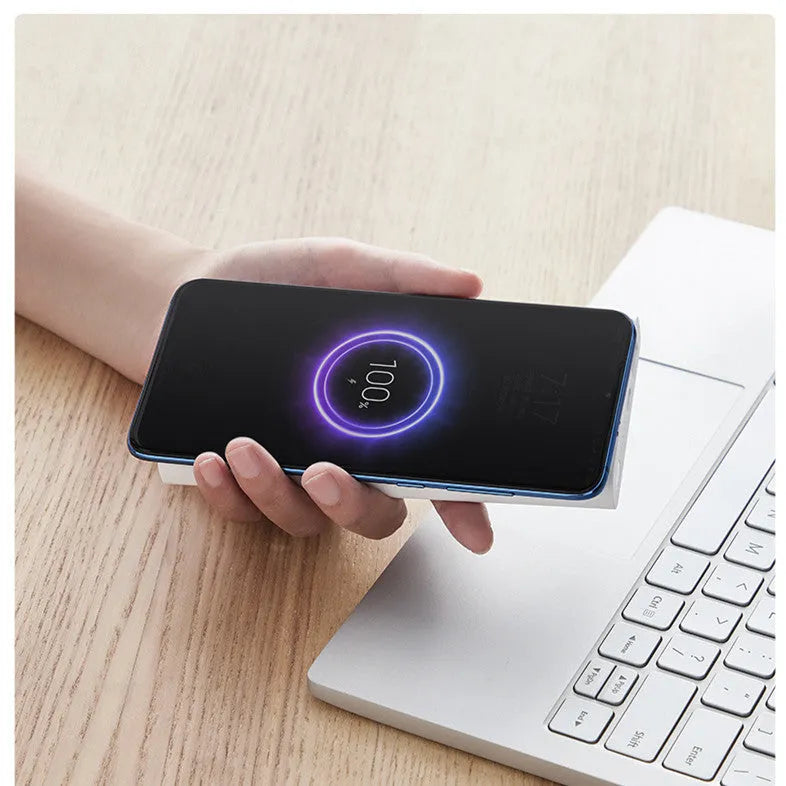 White and black 10000mAh portable power bank with USB-C and USB-A ports for fast and wireless charging.