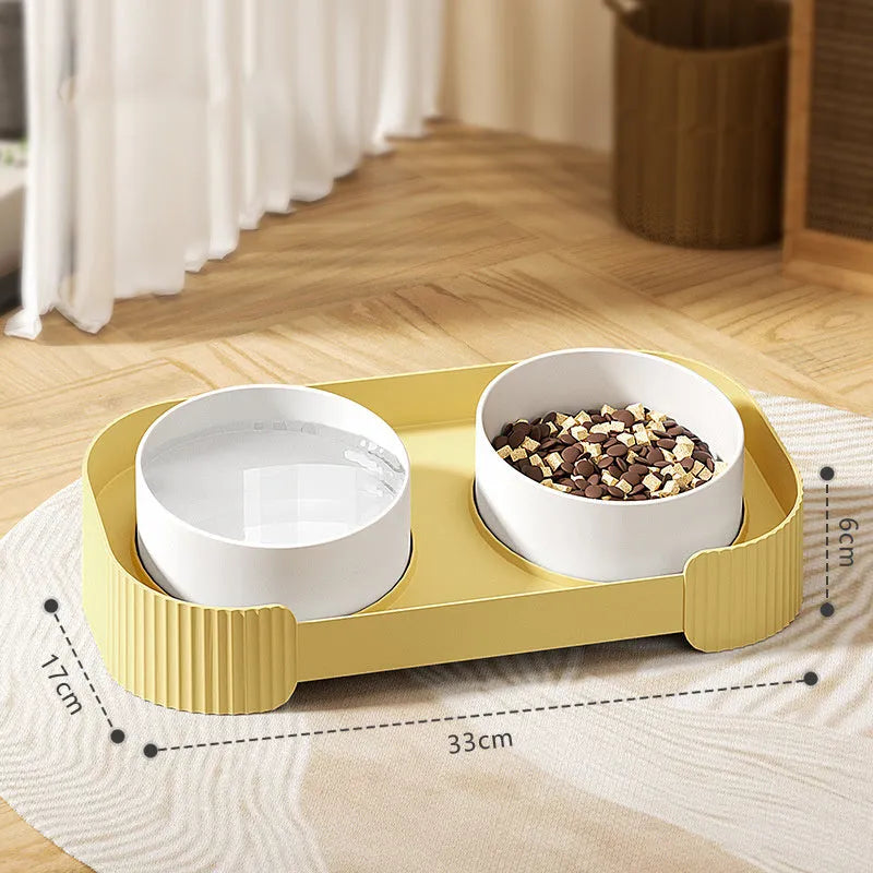 Green ceramic elevated cat bowl set with two bowls on a tilted stand.