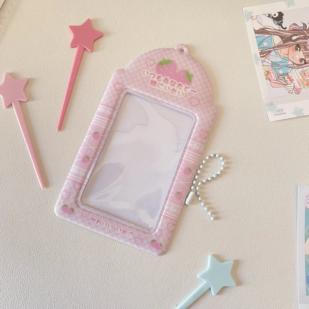 Transparent PVC card holder with cartoon strawberry or four-leaf clover design, measuring 7.6 by 13.6 cm.