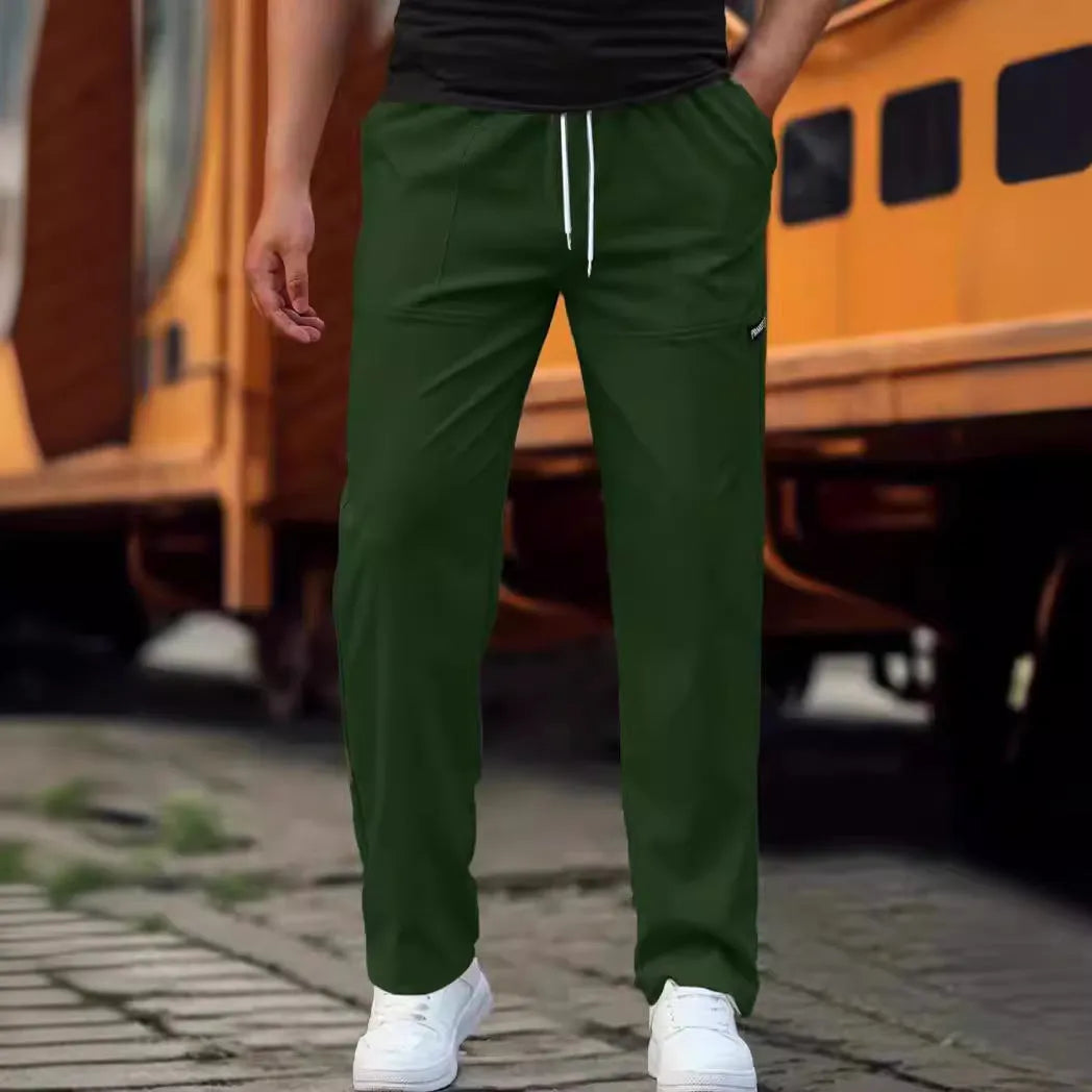 Men's light grey polyester trousers for spring and autumn seasons laid flat.
