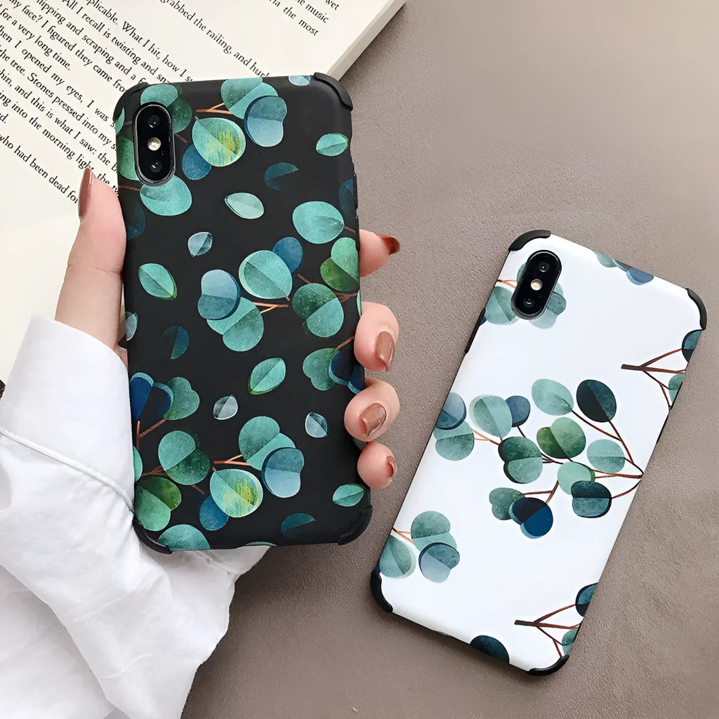 Black silicone iPhone case featuring a printed leaf design, shown fitted to a phone.