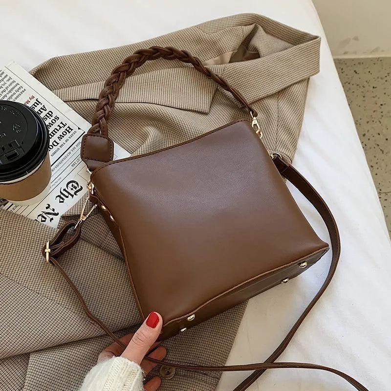 Retro unisex woven PU crossbody bucket bag shown in khaki colour.