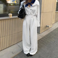 White striped wide-leg women's trousers with a front zip closure on a model