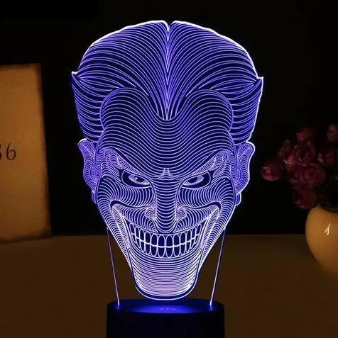 3D acrylic LED table lamp with USB cable and remote control on a desk