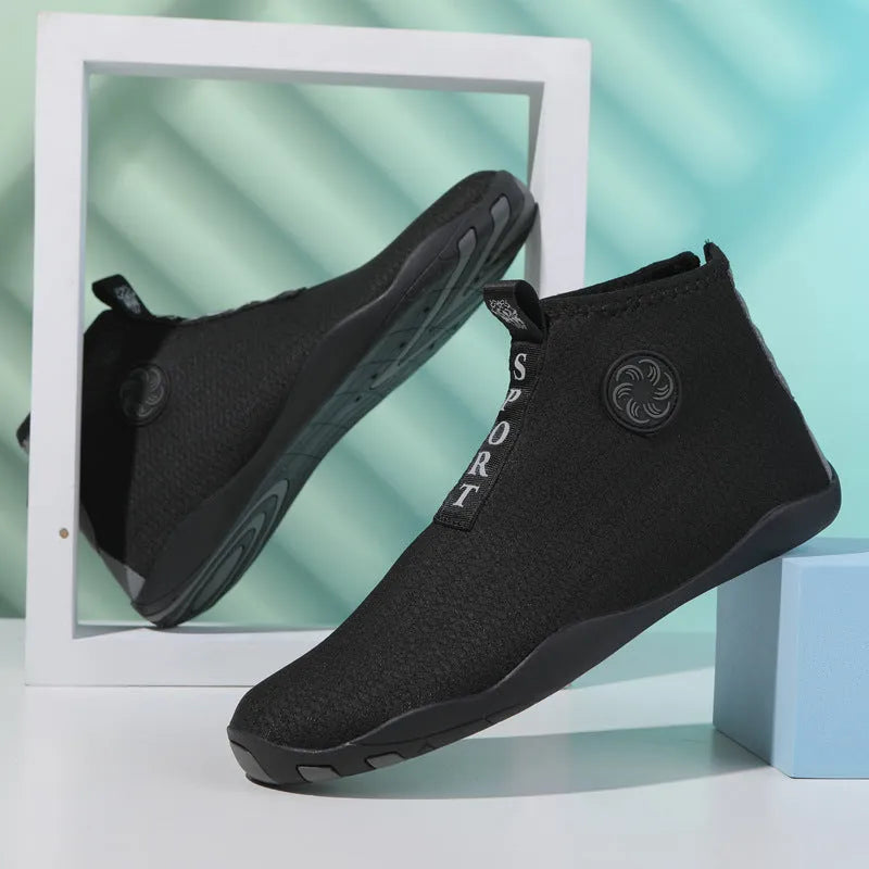 Black and fluorescent green mesh upstream beach shoes with a non-slip rubber sole.
