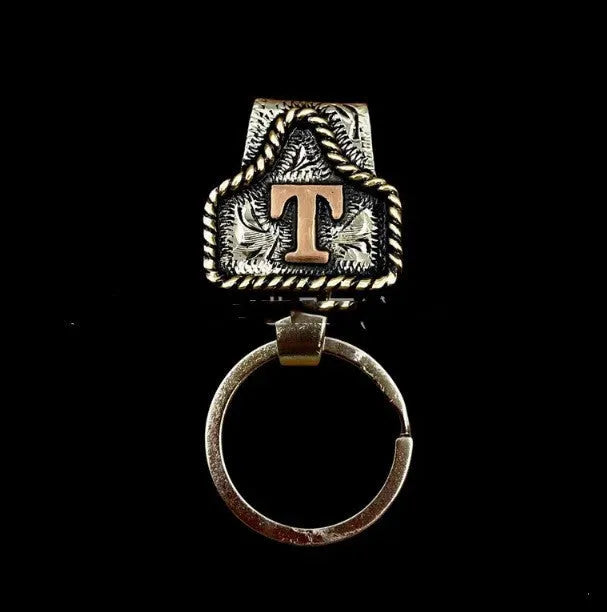 Handmade metal cow tag belt keychain in one of 26 available colours.