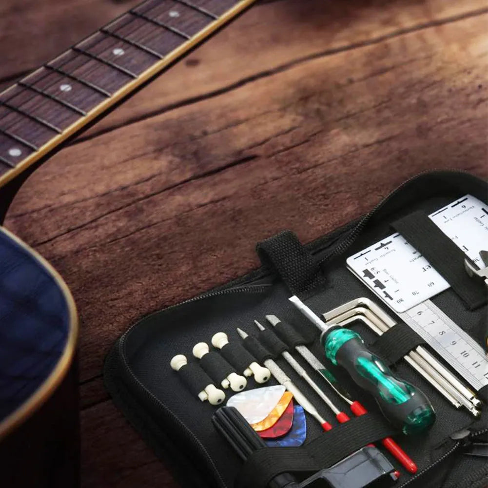 Black compact case open to reveal a guitar repair and maintenance tool kit for guitars, basses, mandolins, and banjos.