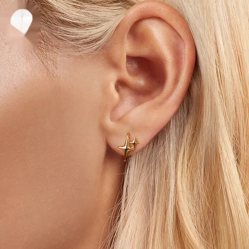 Minimalist oxidised sterling silver star ear clip with XINGX element.