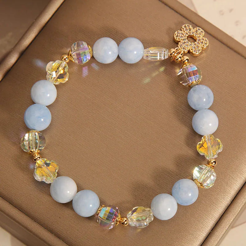 Women's aquamarine crystal four-leaf clover bracelet with pearl detail on adjustable silver chain