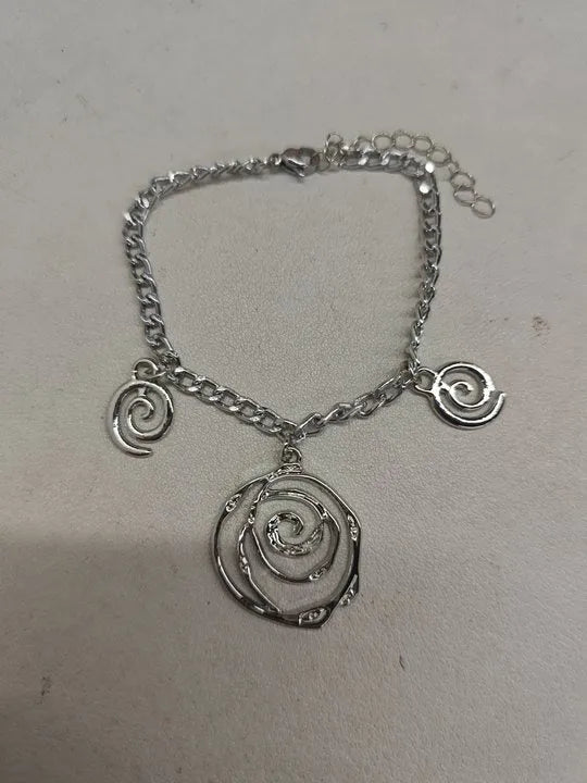 Spiral donut jewellery set showing necklace, bracelet, and earrings in geometric circle design with gold electroplated finish