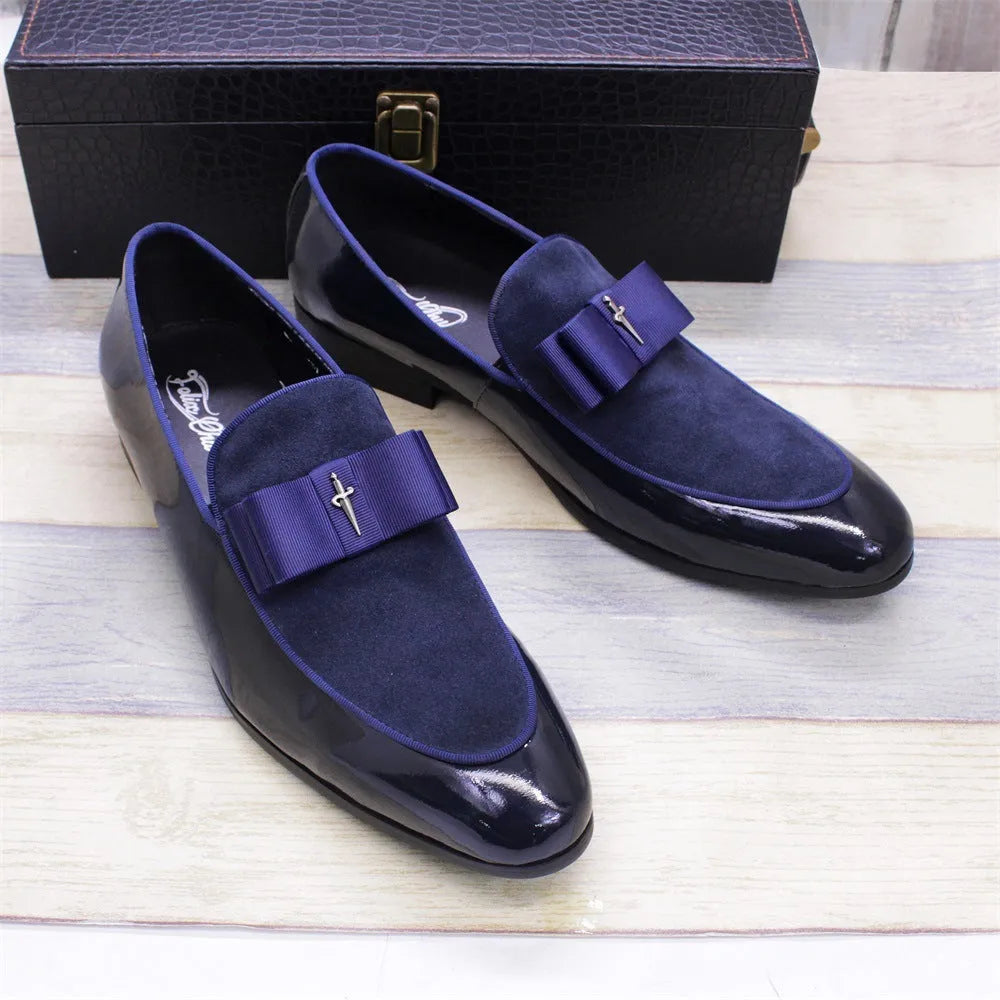 Men's black leather shoes with patent leather finish and a decorative tassel on the front.
