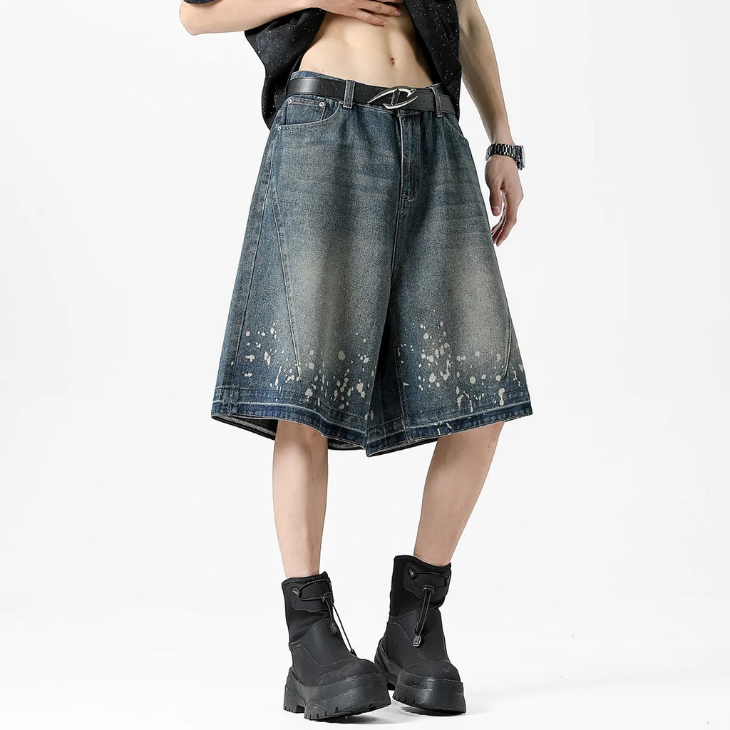 Men's retro blue washed denim shorts with ripped and splash ink distressing detail on straight-leg cut