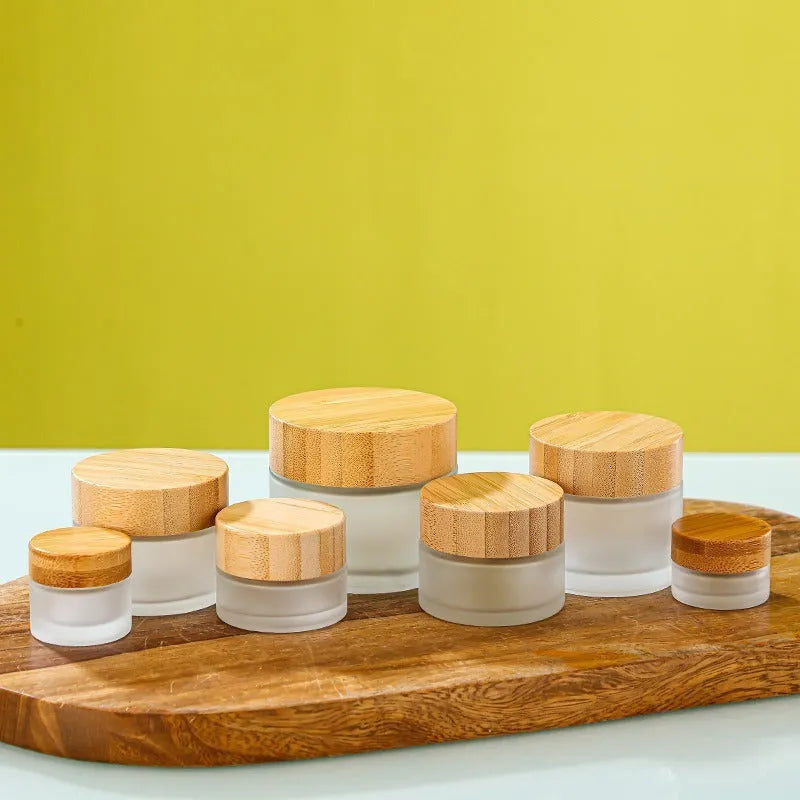 Bamboo wood cover frosted glass cream bottle with inner cushion, shown in transparent and frosted, 50g 60g 100g.