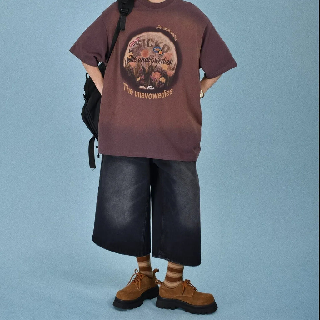 Man wearing light blue straight leg loose fit denim shorts on a summer day.