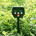 Green solar ultrasonic animal repeller unit showing dimensions and outdoor installation.