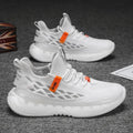 Men's white low-top mesh sneakers with flat rubber sole and front lace-up design on a neutral background.