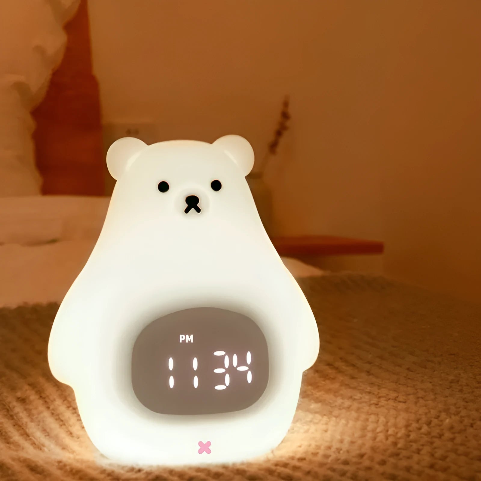 White silicone bear-shaped night light with colour-changing lights and a remote control.