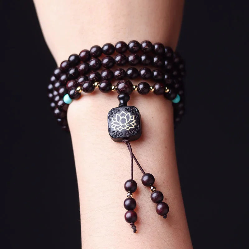 Zambia rosewood Buddha bead bracelet with flat lotus pendant, showing 108 wooden beads.
