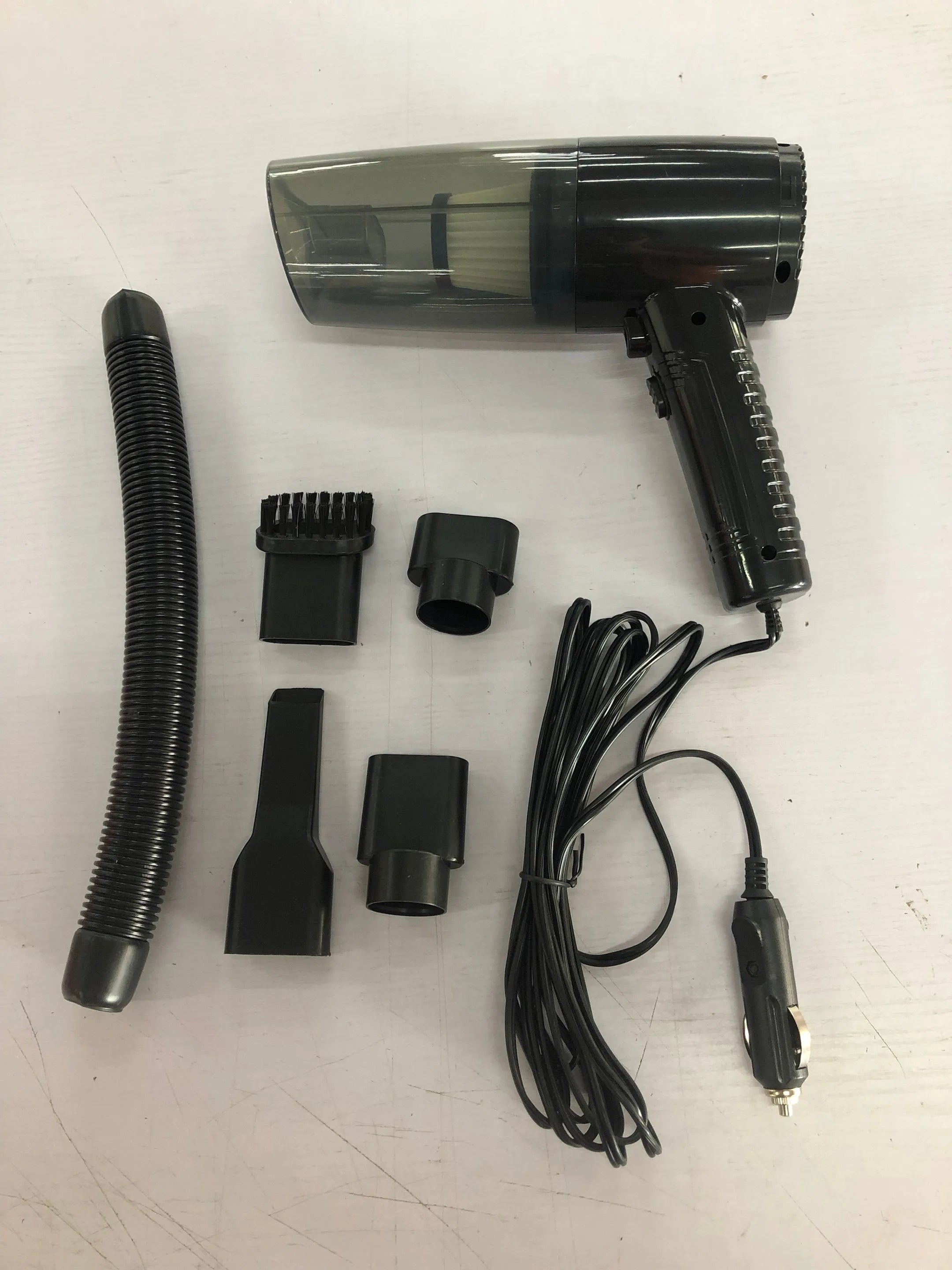Starry Sky Black portable car vacuum cleaner with long cord and set of suction head accessories.