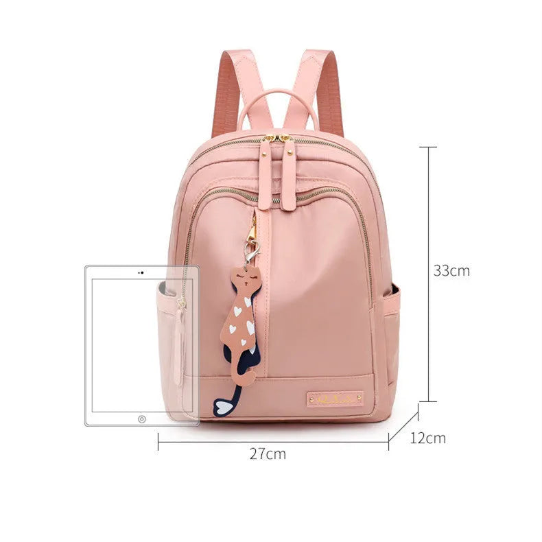 Women's black casual nylon backpack with double straps and a front pocket, shown next to a pink version.