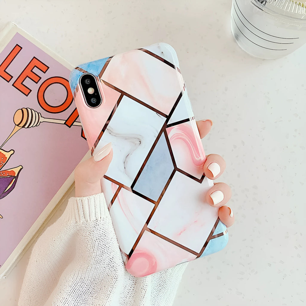 Flexible silicone mobile phone case for various iPhone models on a table.