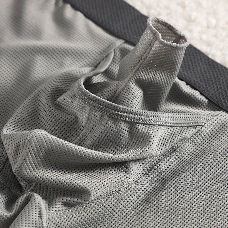 Solid colour men's ice silk boxer shorts with a low waist and knitted mesh fabric.